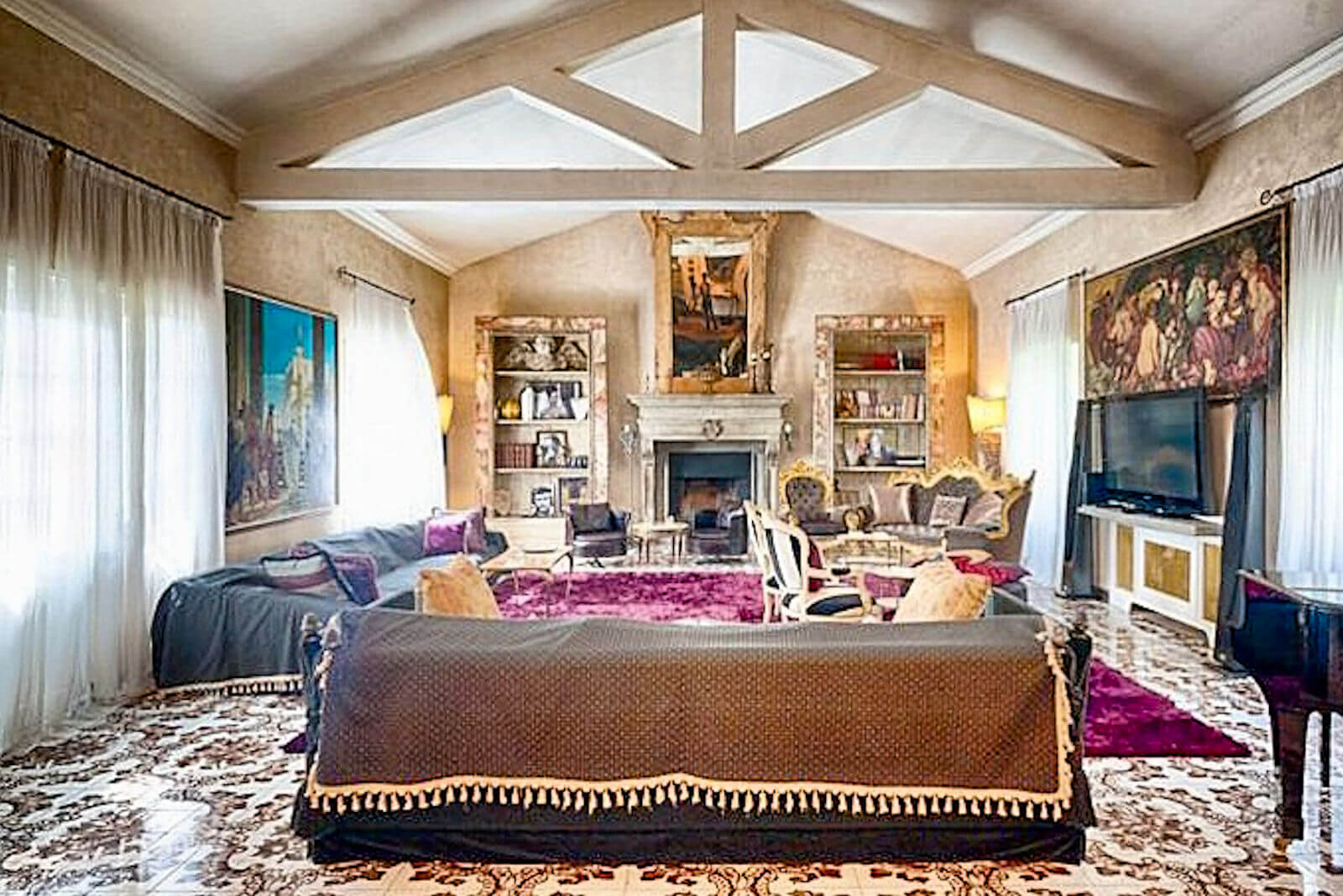 Main salon at Villa InCanto with exposed beams and chandelier for private events